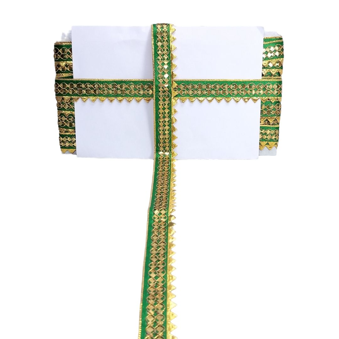 White saree with green and gold border on a white background