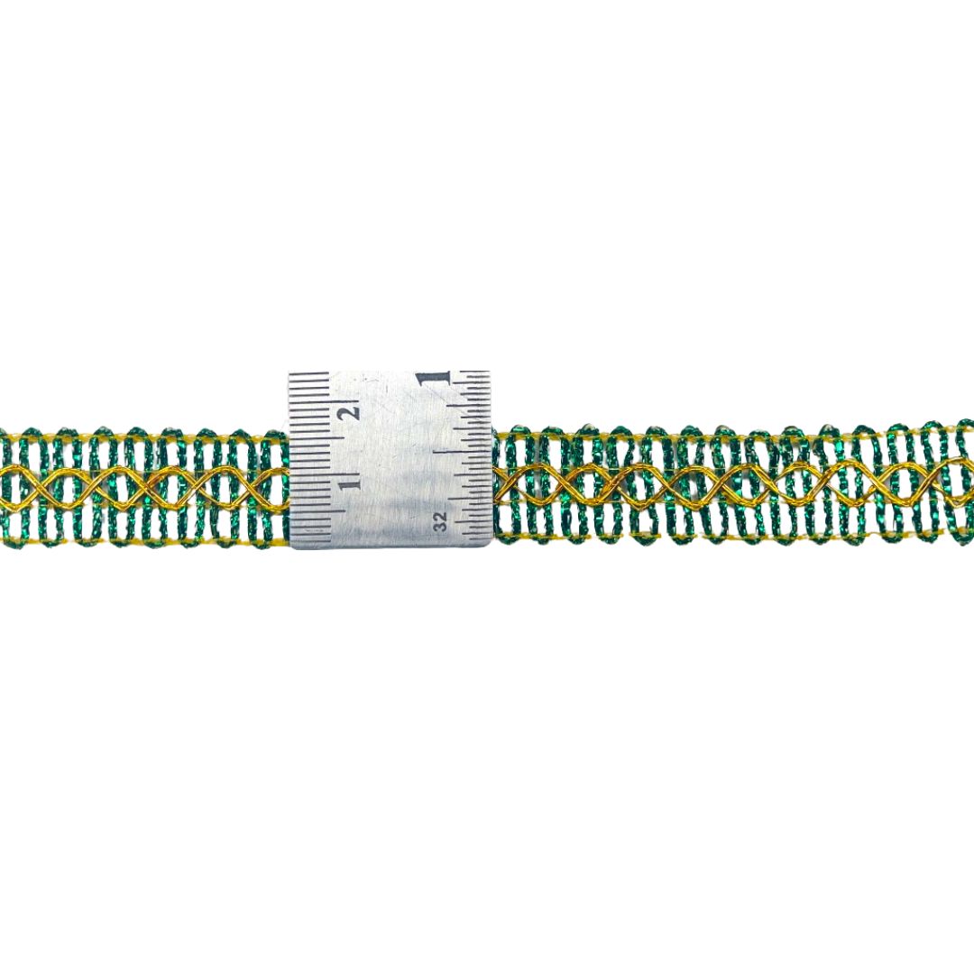 Green and gold braided trim with a ruler for scale on a white background