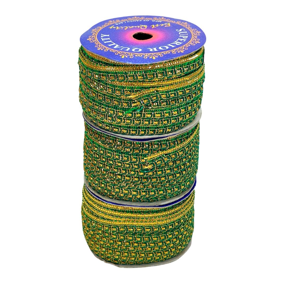 Spool of green and gold ribbon with decorative label on a white background