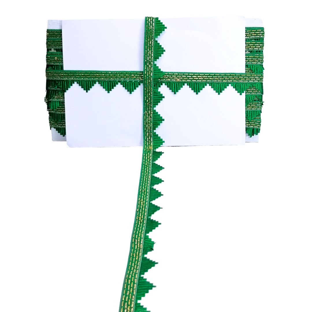Green and white decorative item with intricate patterns on a white background