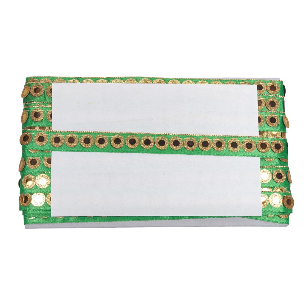 Green clutch with gold embellishments on a white background