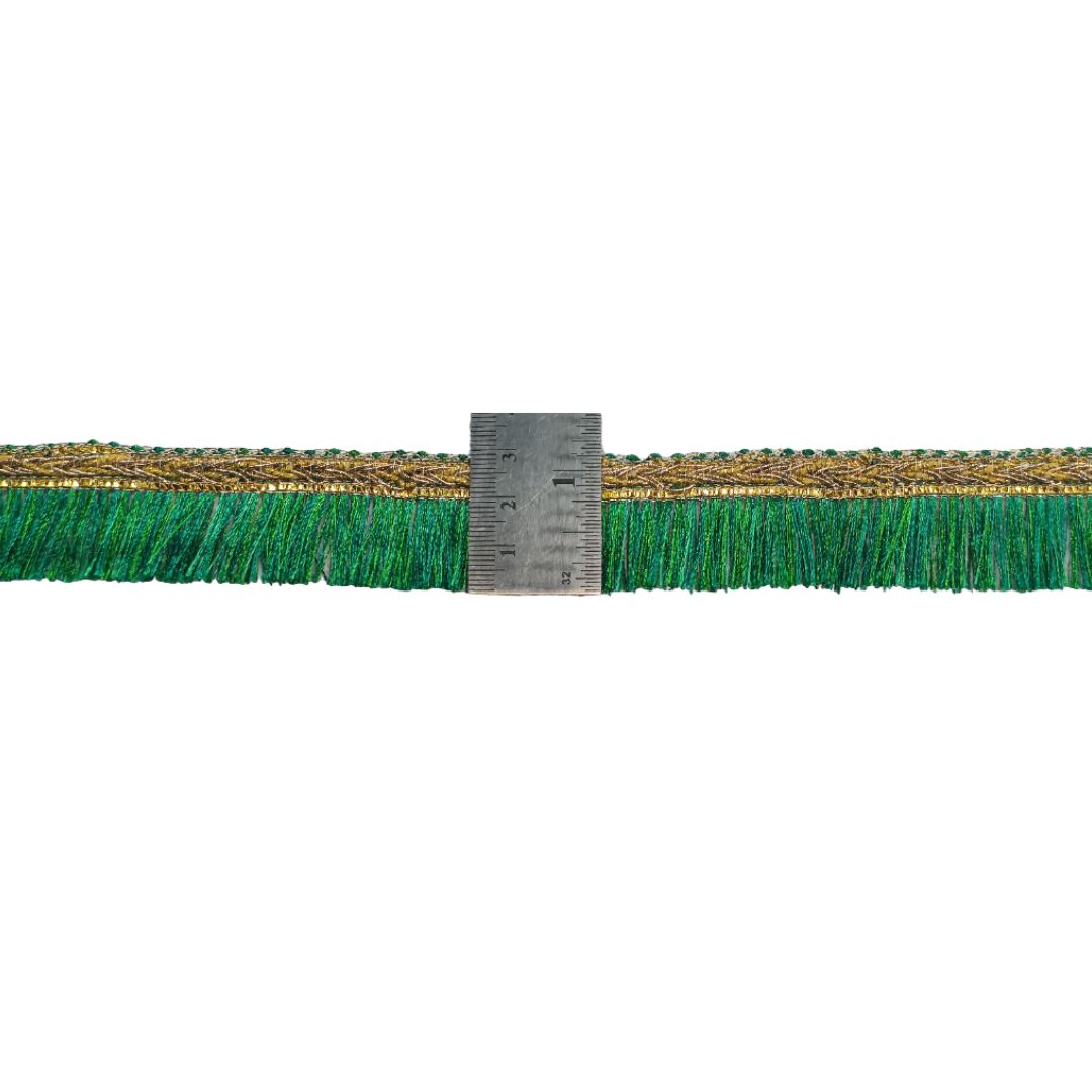 Green synthetic grass strip with a ruler for scale on a white background