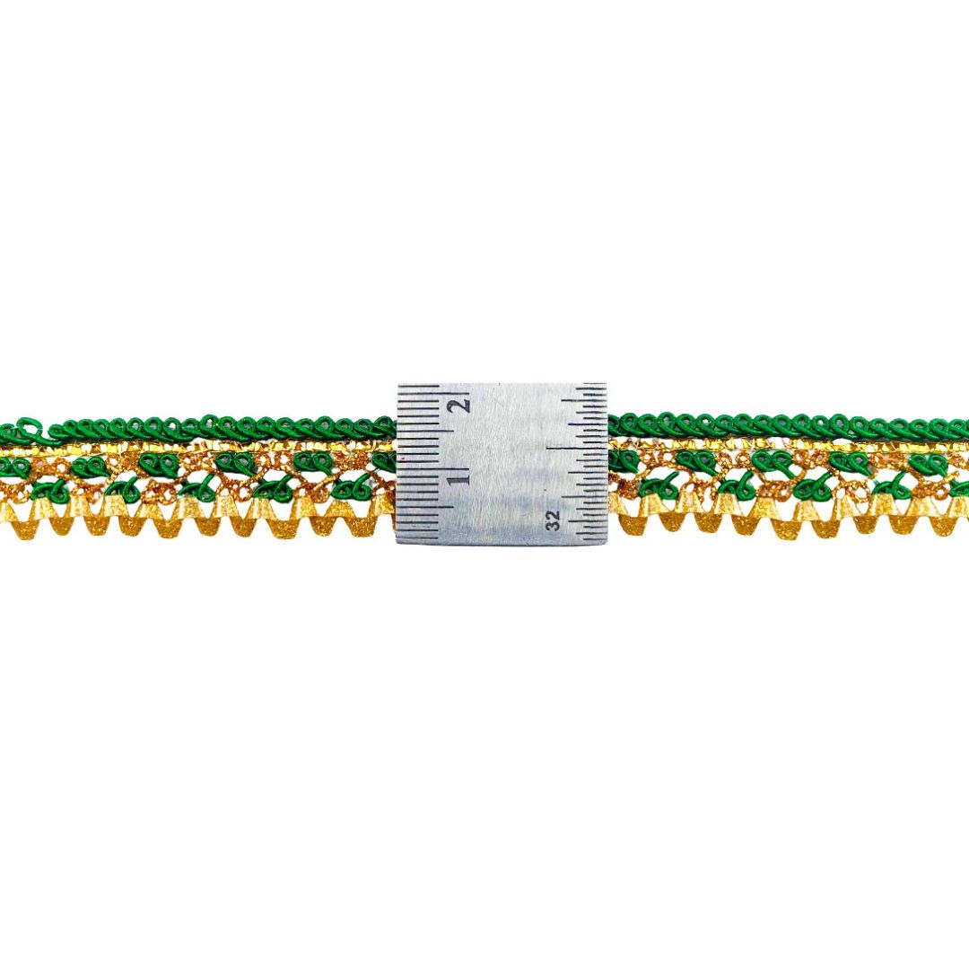 Close-up of green and gold beaded trim with a ruler for scale on a white background