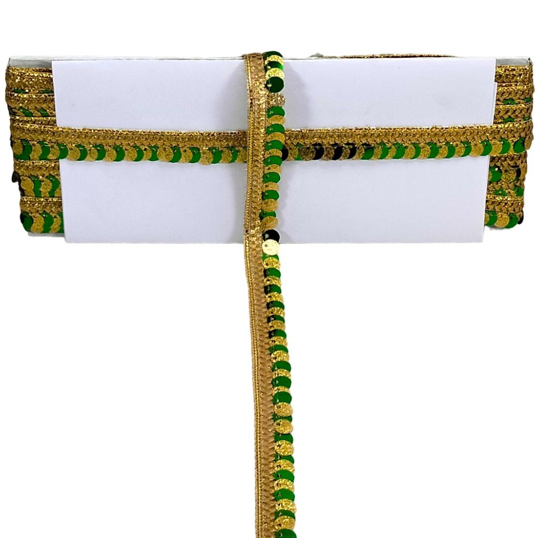 White clutch bag with gold and green decorative trim on a white background