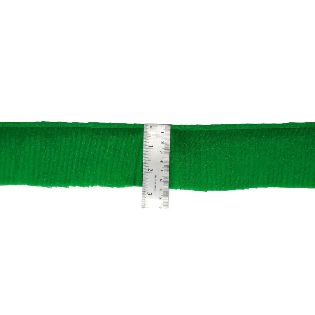 Green ribbon with a ruler for measurement on a white background