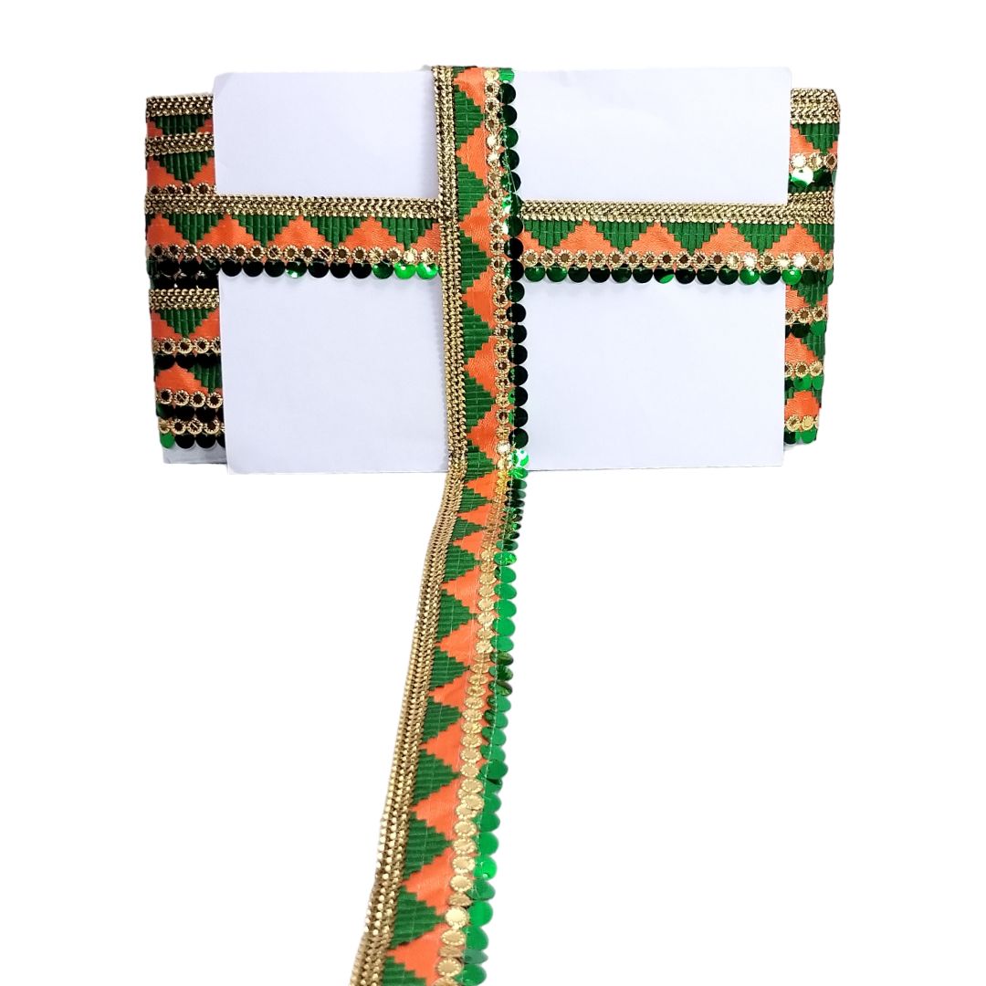Decorative fabric border with green, orange, and gold pattern on a white background