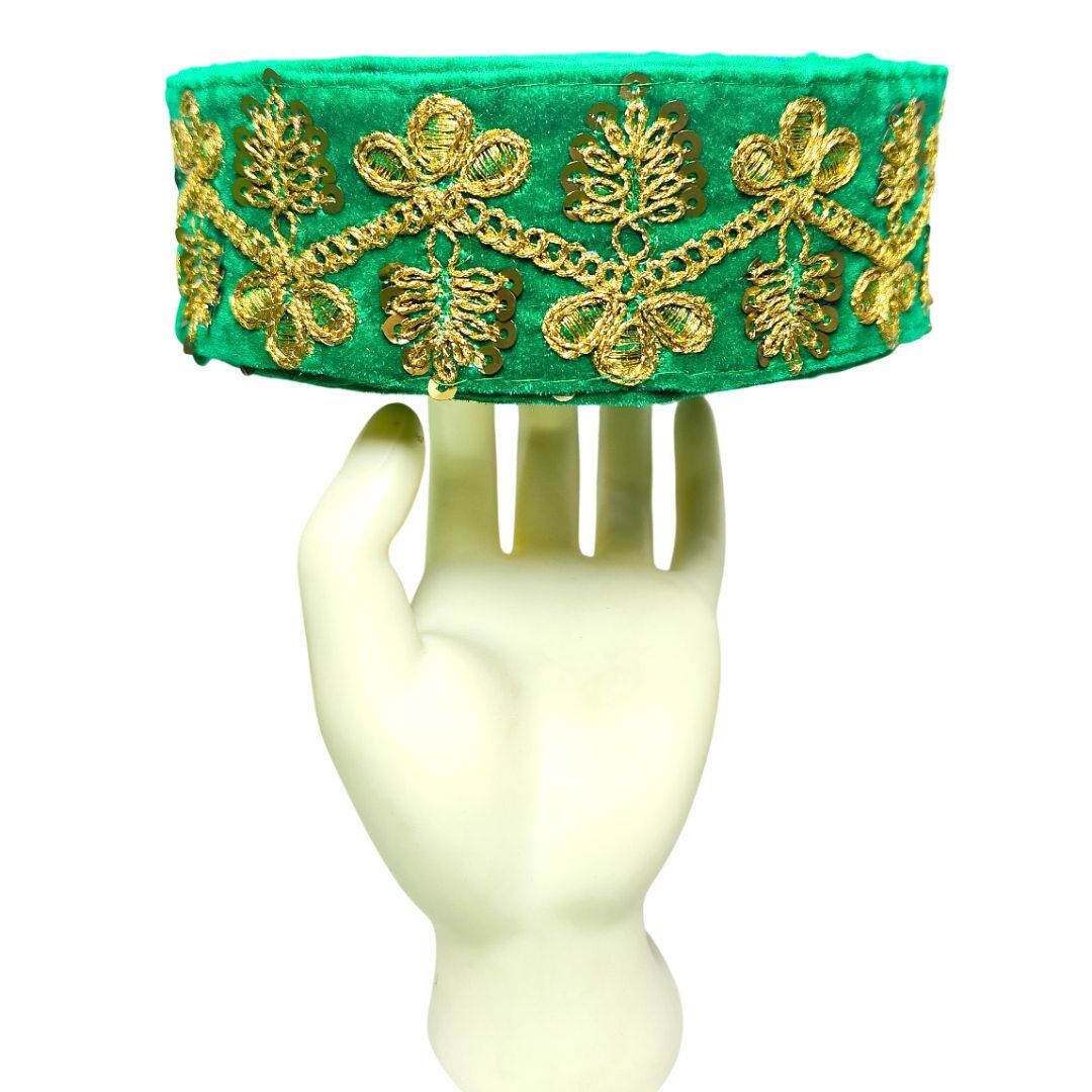Green headband with gold embroidery on a mannequin head