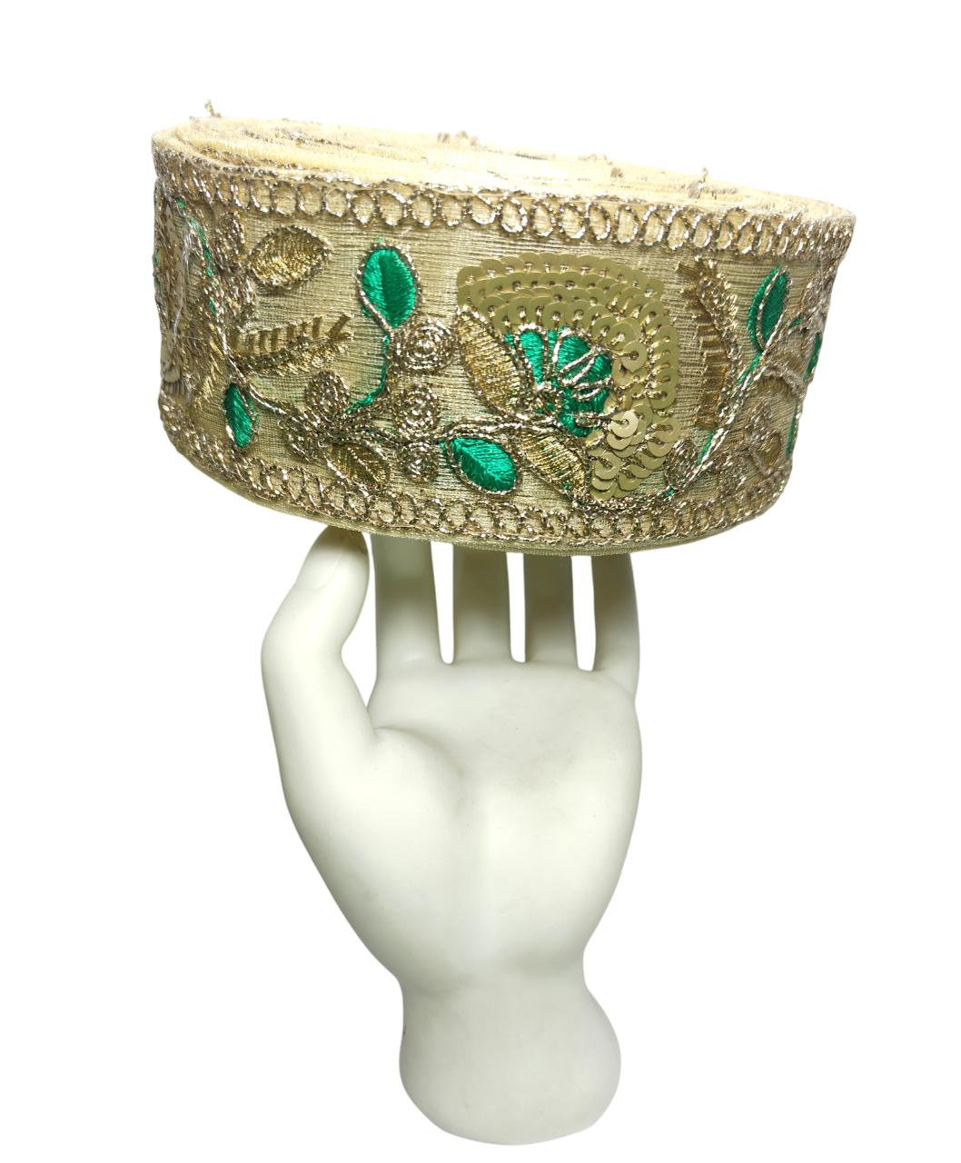 Decorative headband with floral patterns on a white mannequin hand