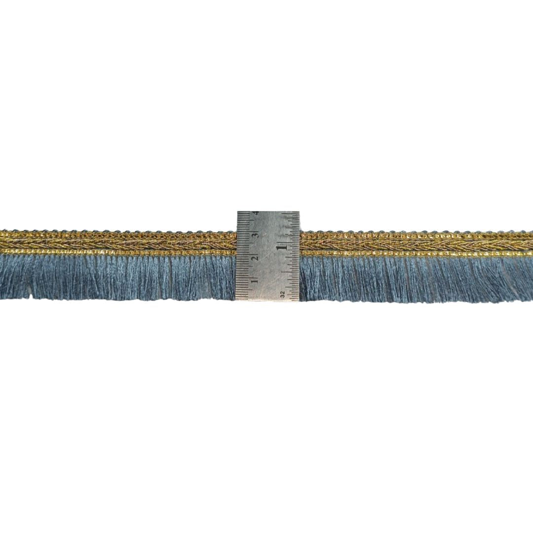 Strip of blue and gold fabric with a ruler for scale on a white background