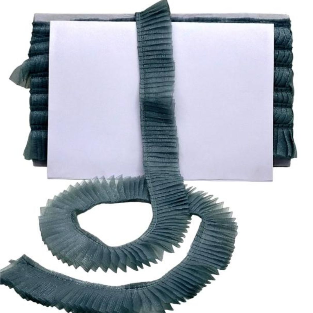 Roll of green pleated ribbon with a white background