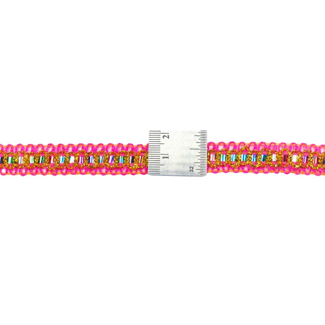 Beaded bracelet with colorful beads and a ruler for size reference on a white background