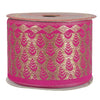 Spool of pink and gold patterned ribbon on a white background