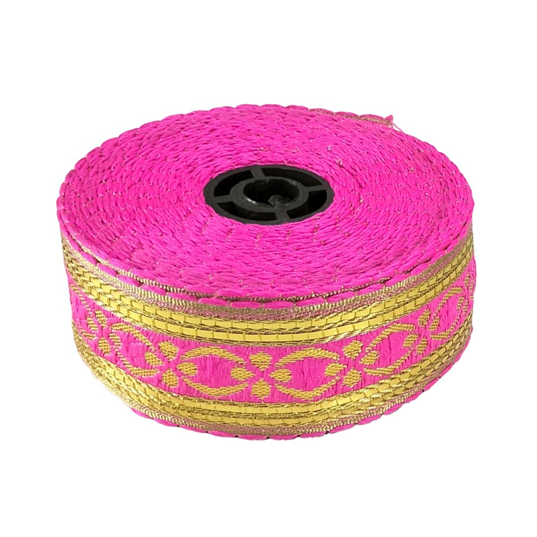 Roll of pink and gold decorative tape on a white background