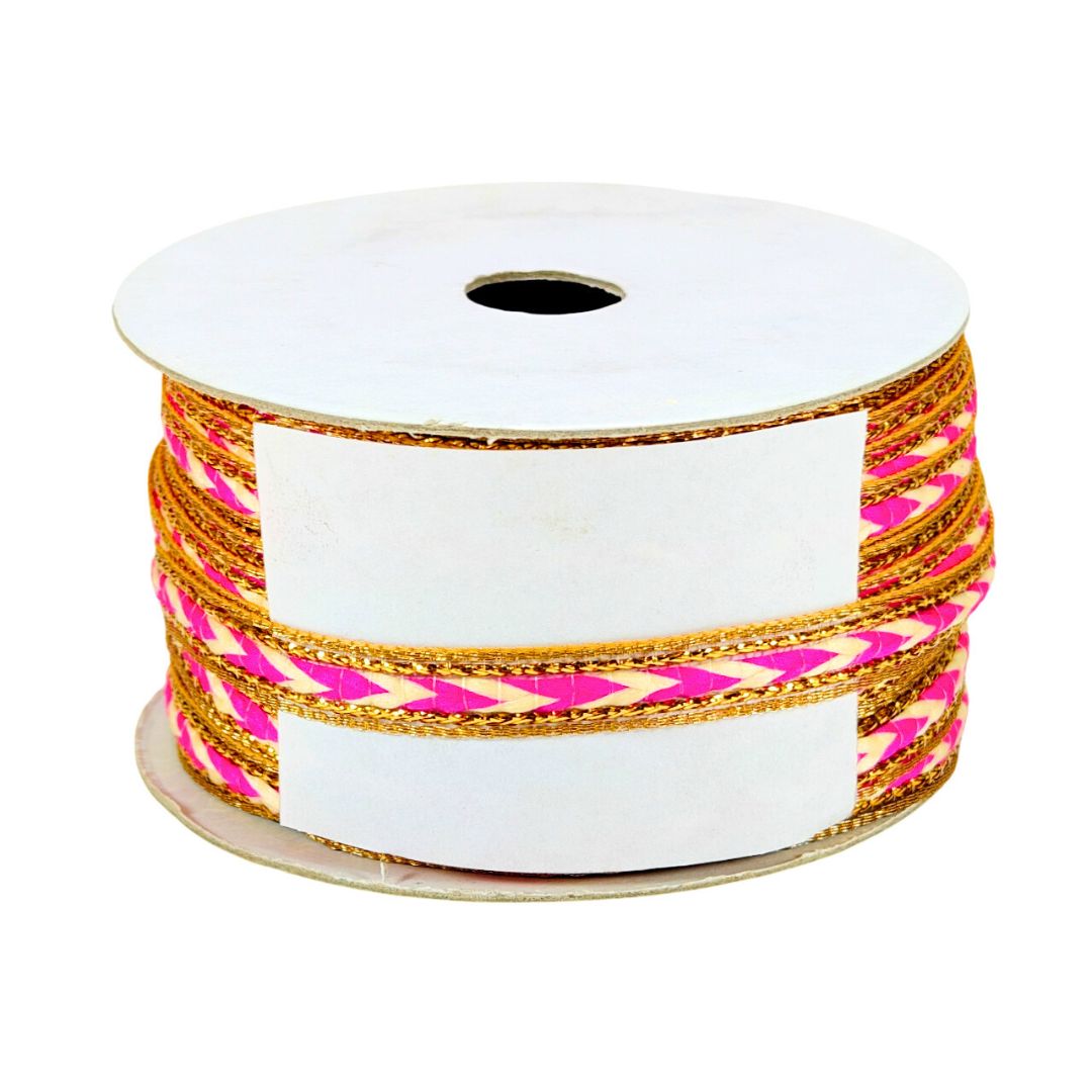 Spool of ribbon with pink and gold pattern on a white background