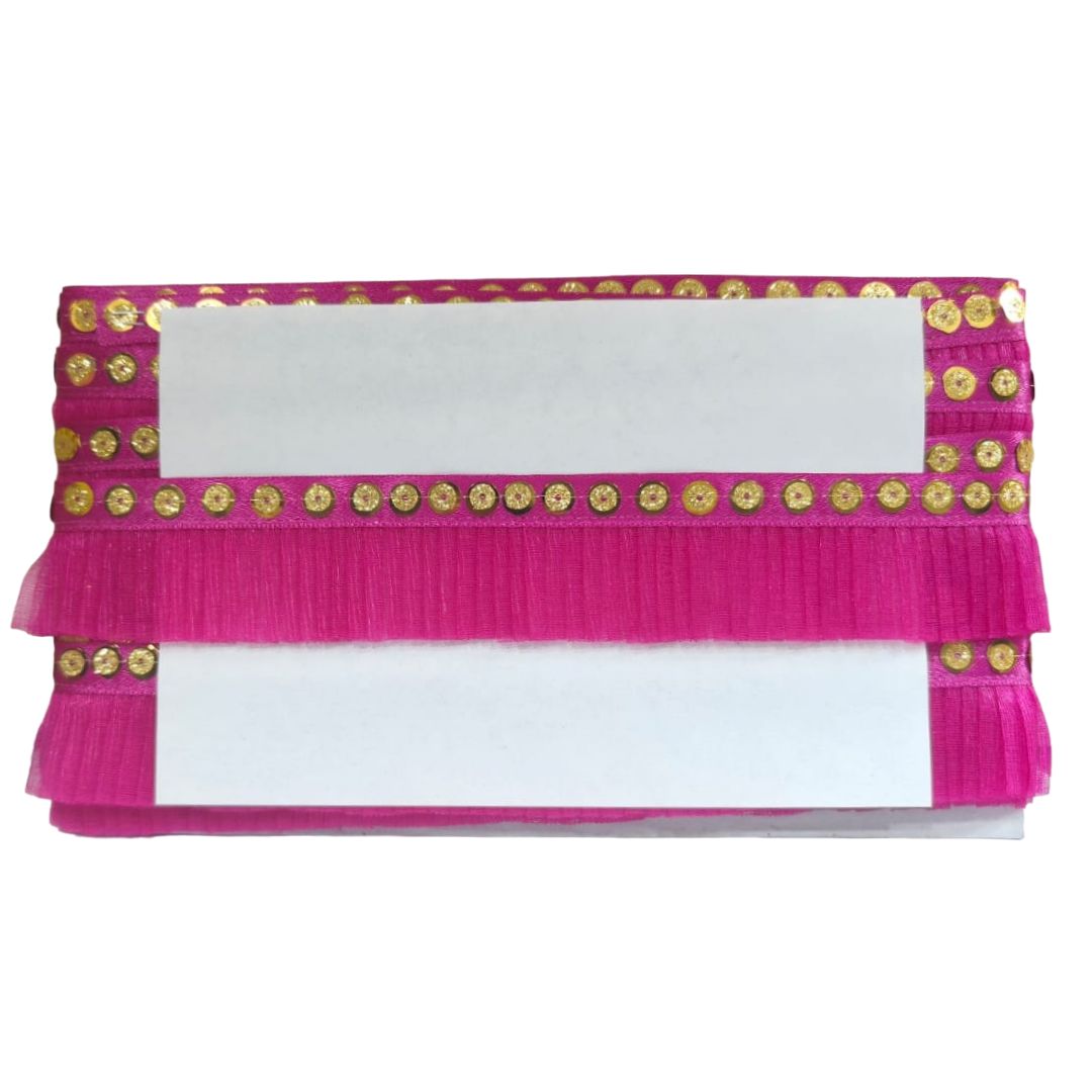 Pink fabric with gold embellishments on a white background