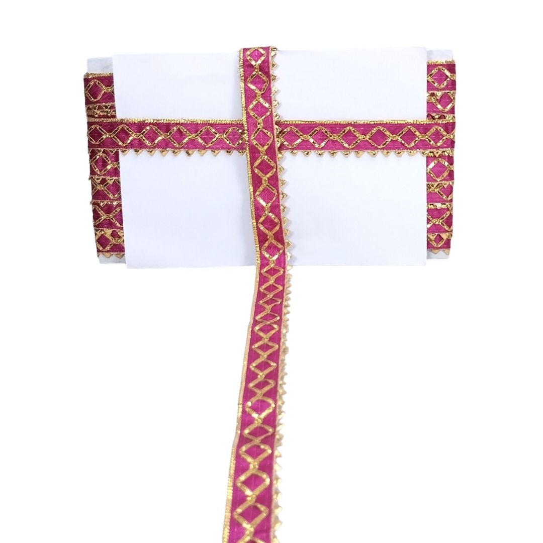 White garment with pink and gold decorative straps on a white background