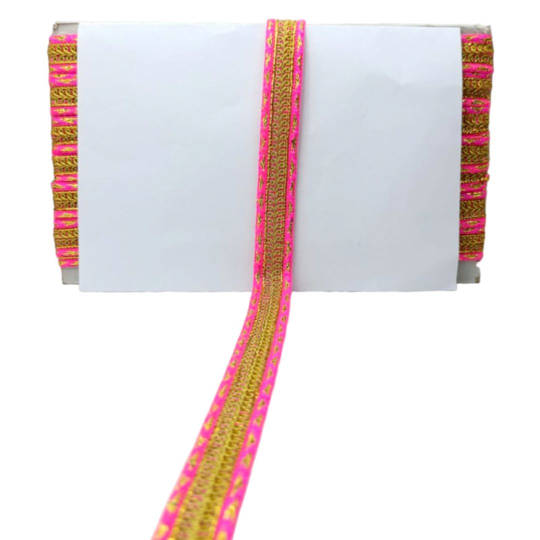 White fabric with pink and gold decorative trim on a white background