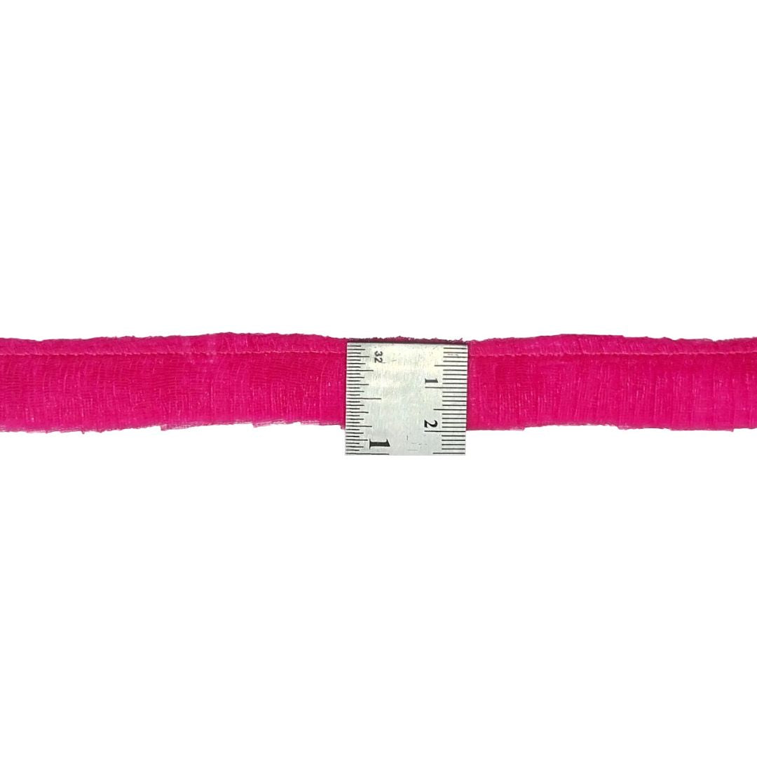 Pink ribbon with a ruler for measurement on a white background