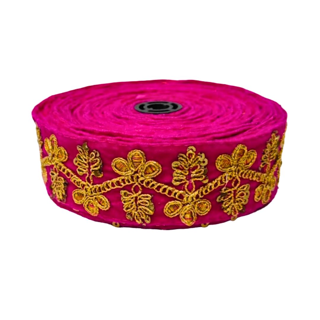 Roll of pink fabric with gold embroidery on a white background