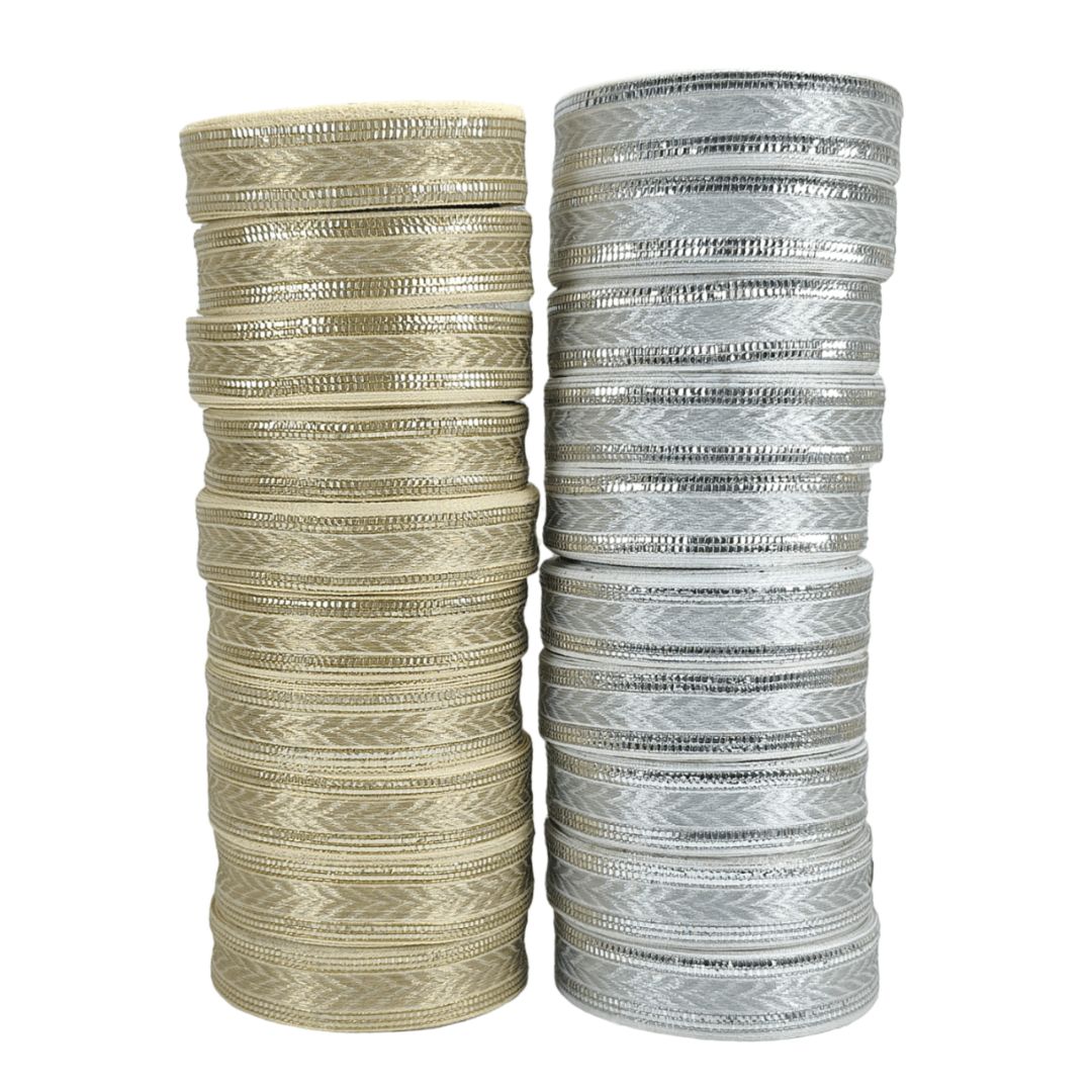 Two stacks of bangles, one beige and one silver, on a white background.