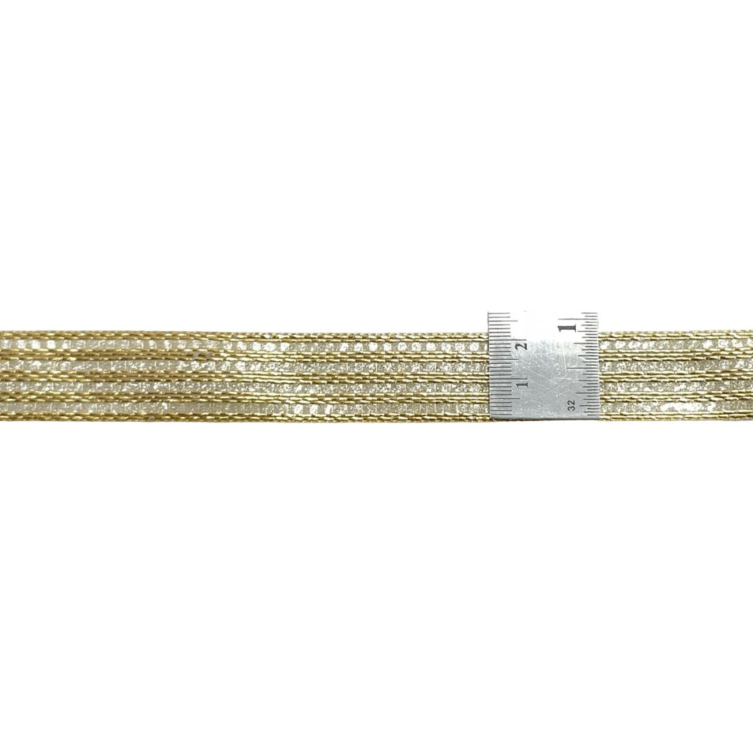 Gold chain with a ruler for scale on a white background