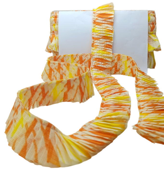Set of orange and yellow scrunchies on a white background