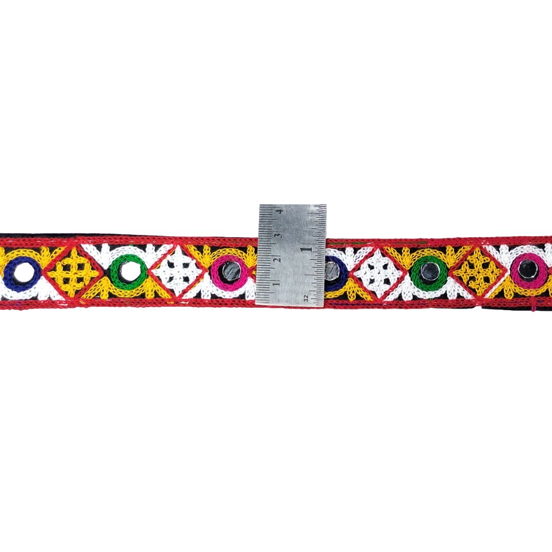 Decorative band with colorful patterns and a ruler for scale on a white background