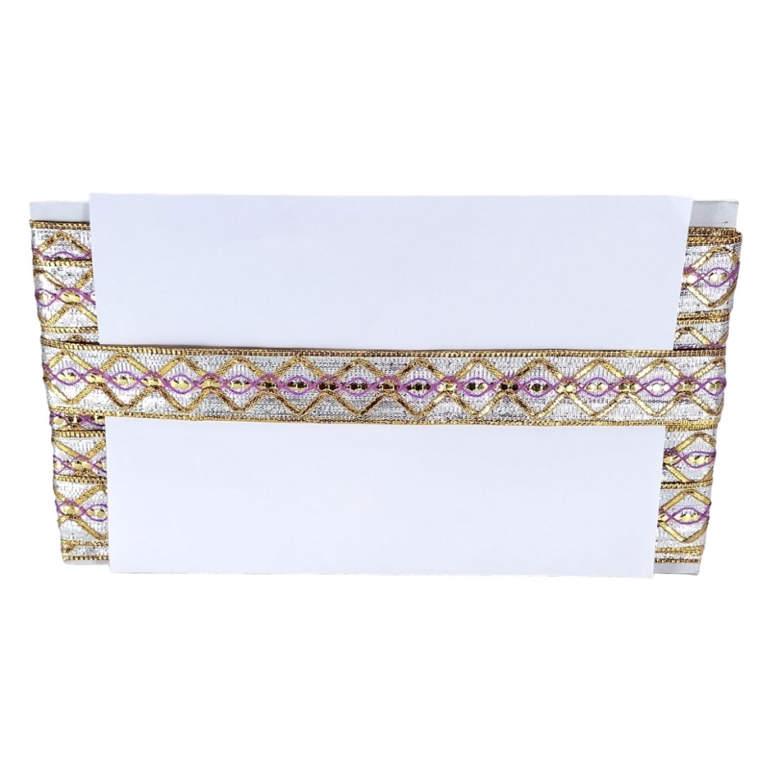 Decorative table runner with gold and purple patterns on a white background