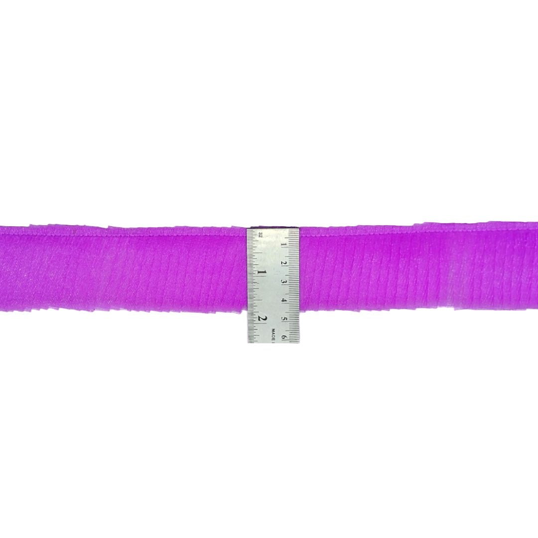 Purple ribbon with a ruler for measurement on a white background
