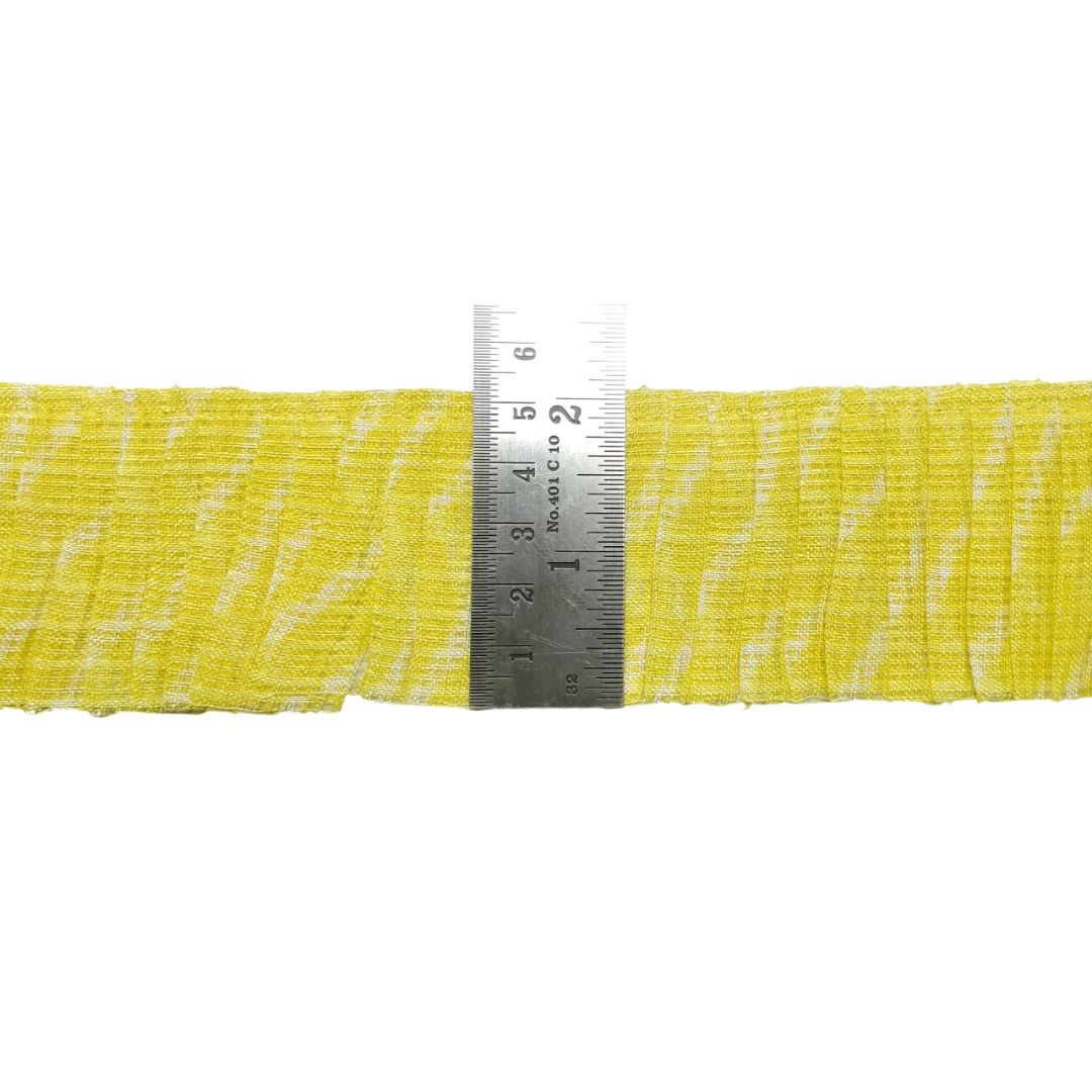 Yellow webbing strap with a metal ruler for measurement on a white background
