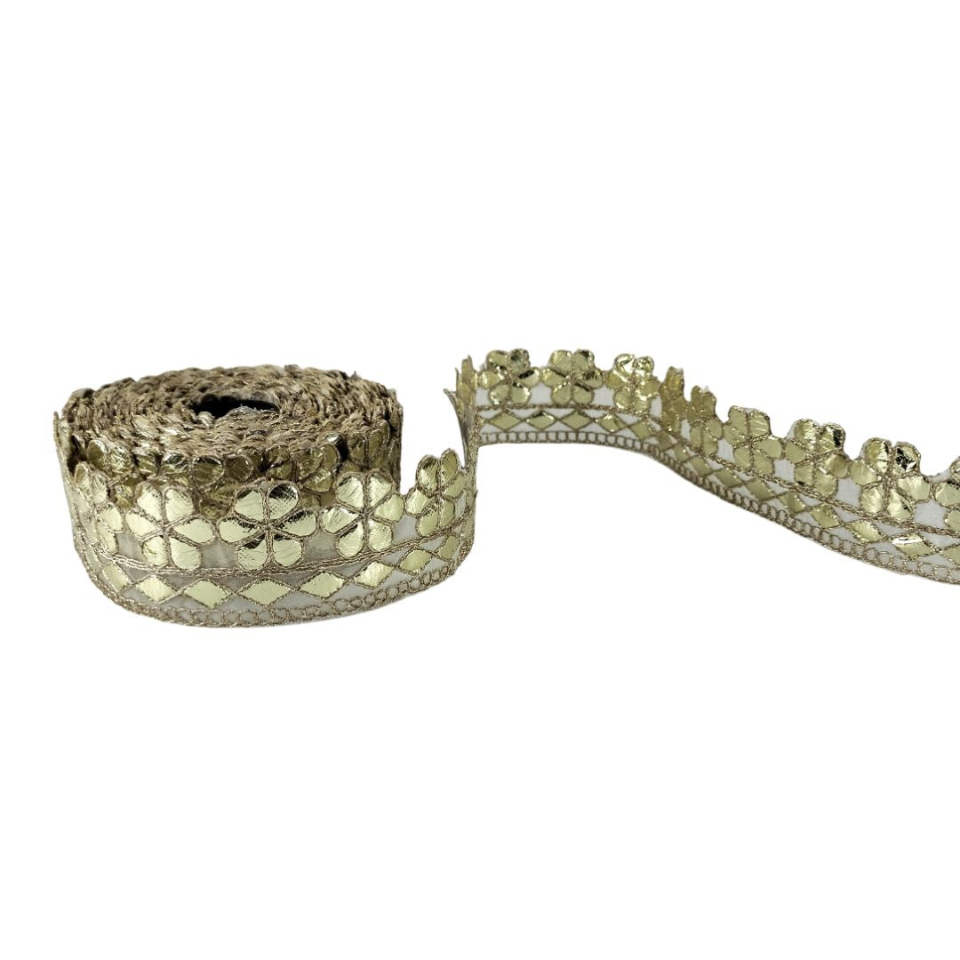 Decorative ribbon with gold floral pattern on a white background