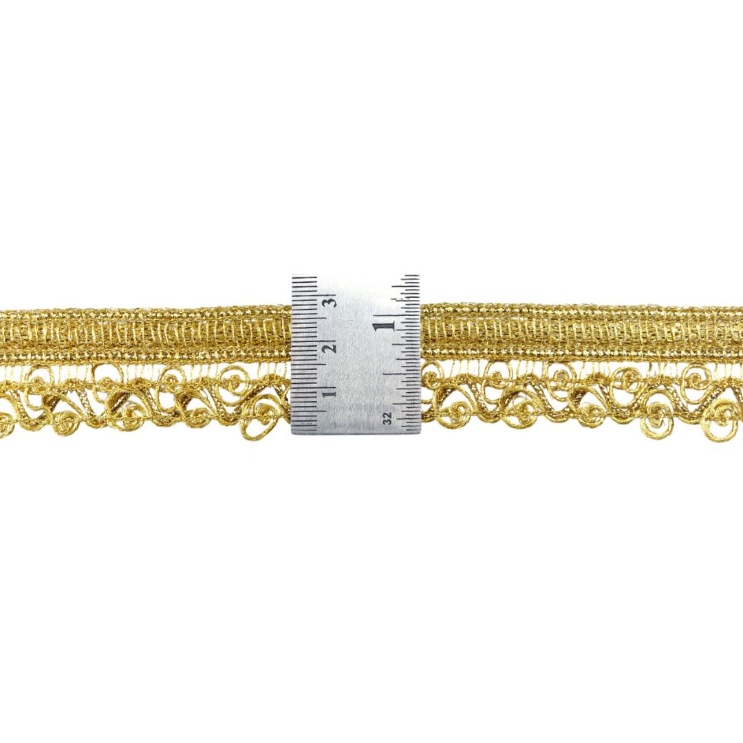 Gold lace trim with a measuring ruler on a white background
