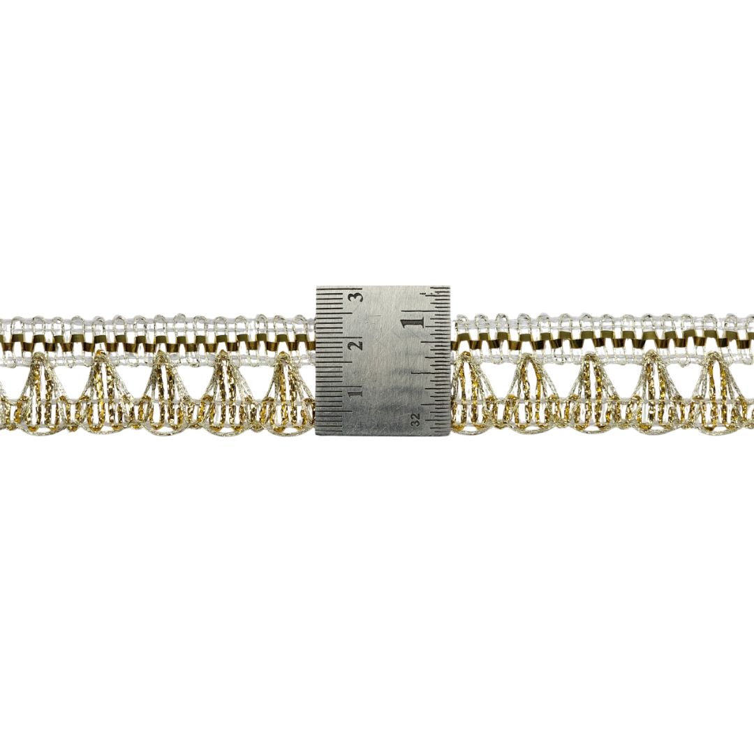 Gold lace trim with a ruler for measurement on a white background