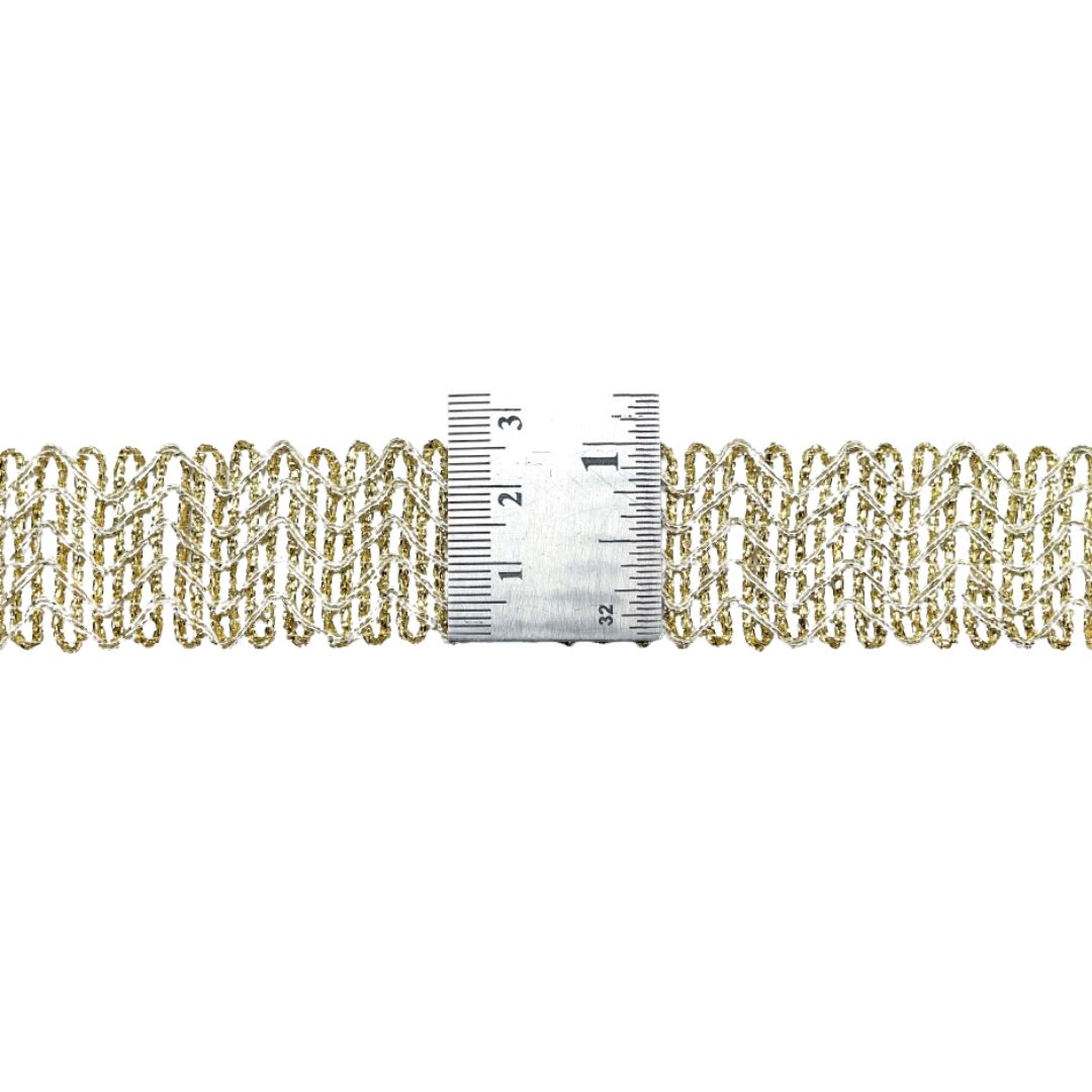 Gold chain with a ruler for scale on a white background