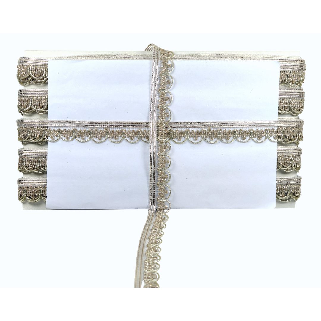 White clutch bag with gold lace detailing on a white background