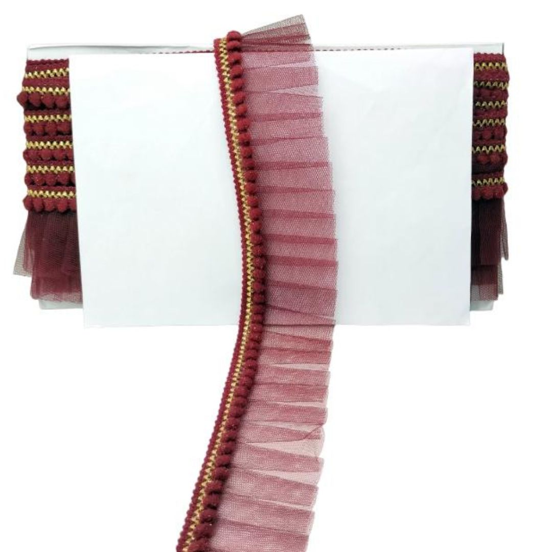 Maroon ribbon with gold trim on a white background