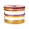 Spool of gold and red braided ribbon on a white background