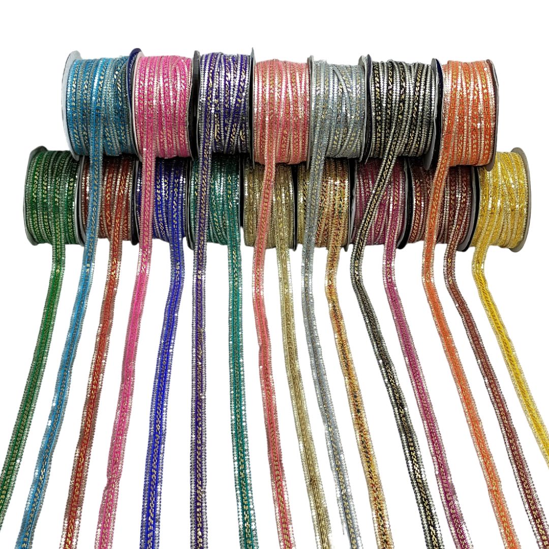 Assorted colorful ribbons on spools against a white background