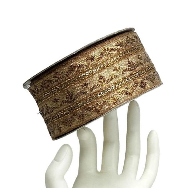 Decorative band on a white mannequin hand against a white background
