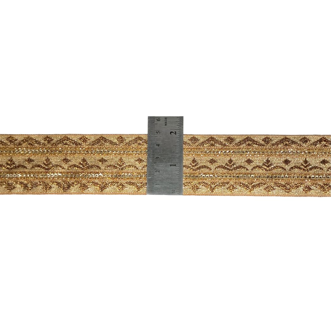 Decorative ribbon with lace pattern and a ruler for scale on a white background