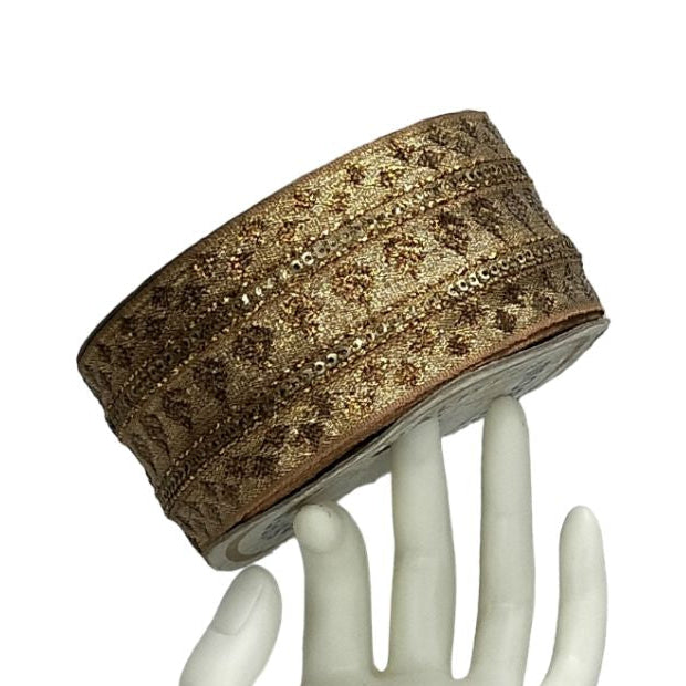 Decorative headband on a white mannequin hand against a white background