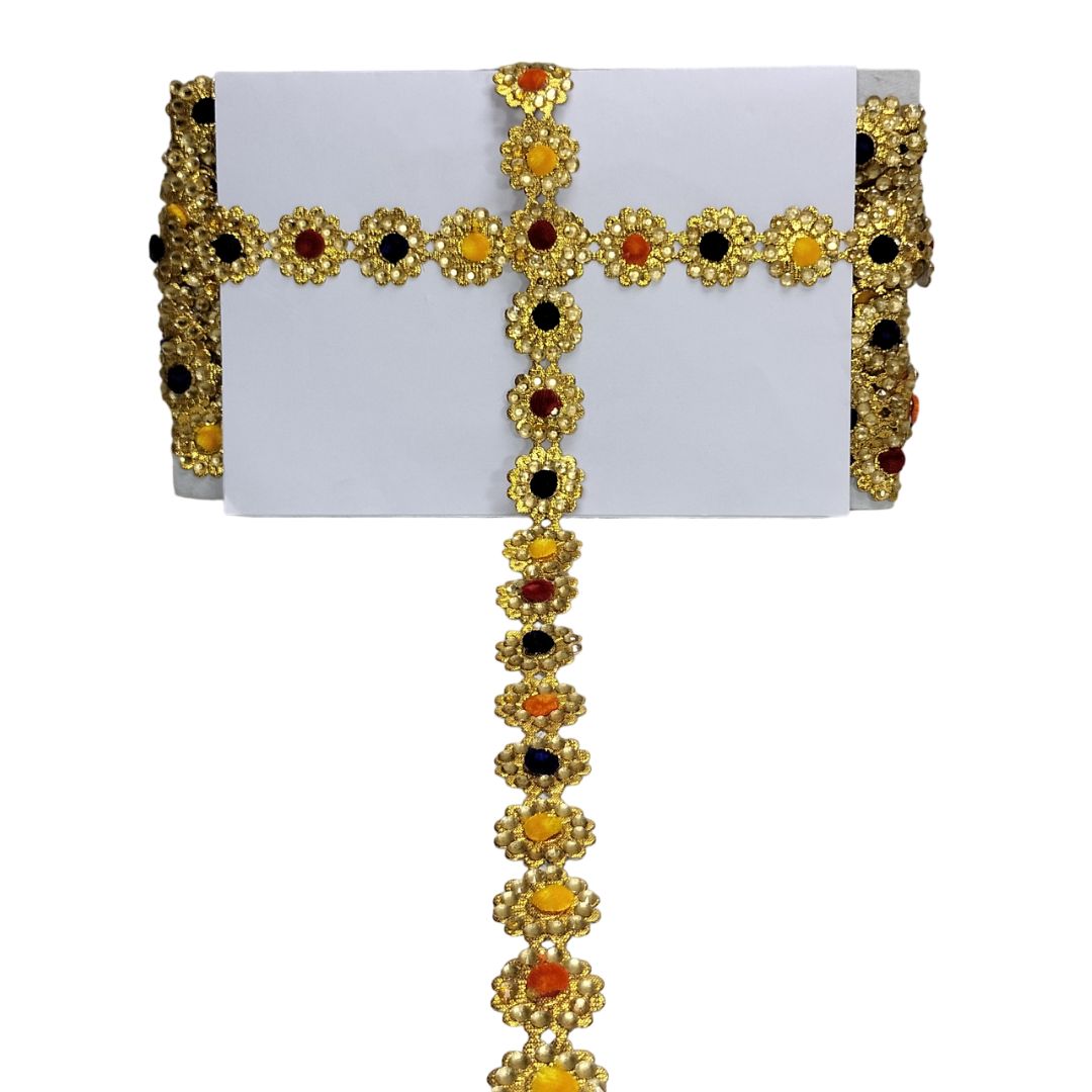 Decorative gold chain with colored stones on a white card