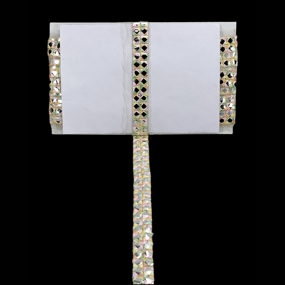 Pair of long, thin earrings with rhinestone detailing on a white card against a black background.