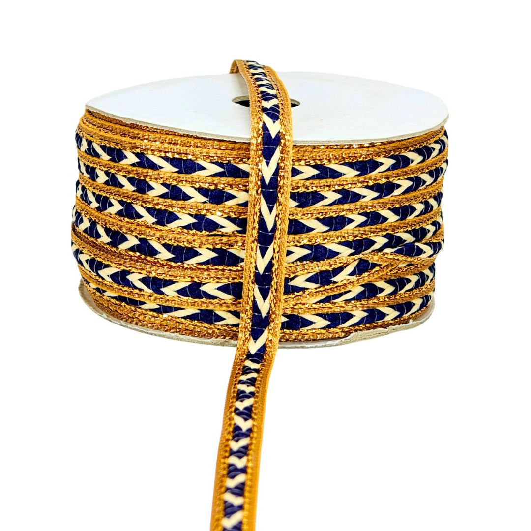 Roll of blue and gold patterned rope on a white background