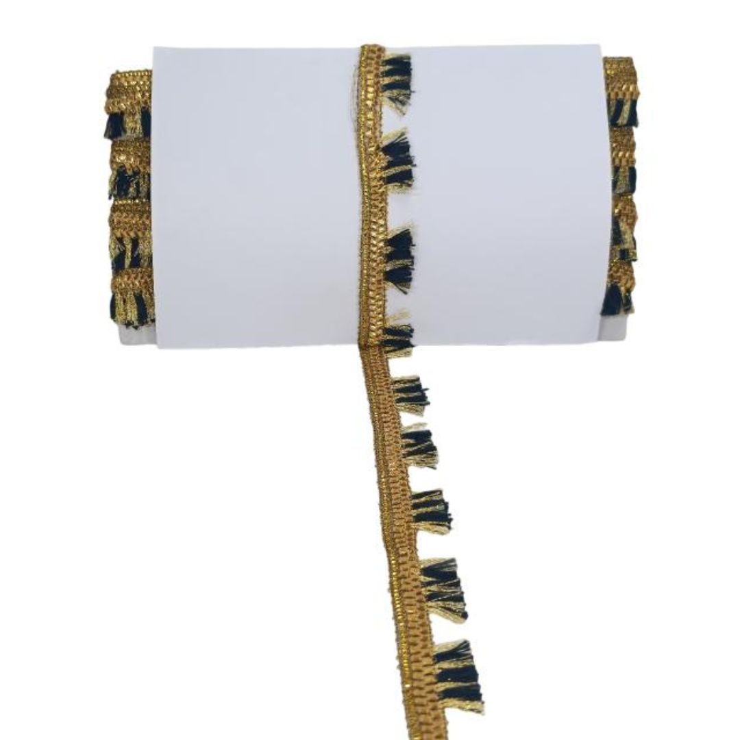 Decorative table runner with gold and black fringe on a white background