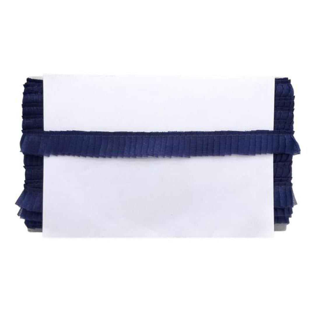White clutch with navy blue ruffled edge on a white background