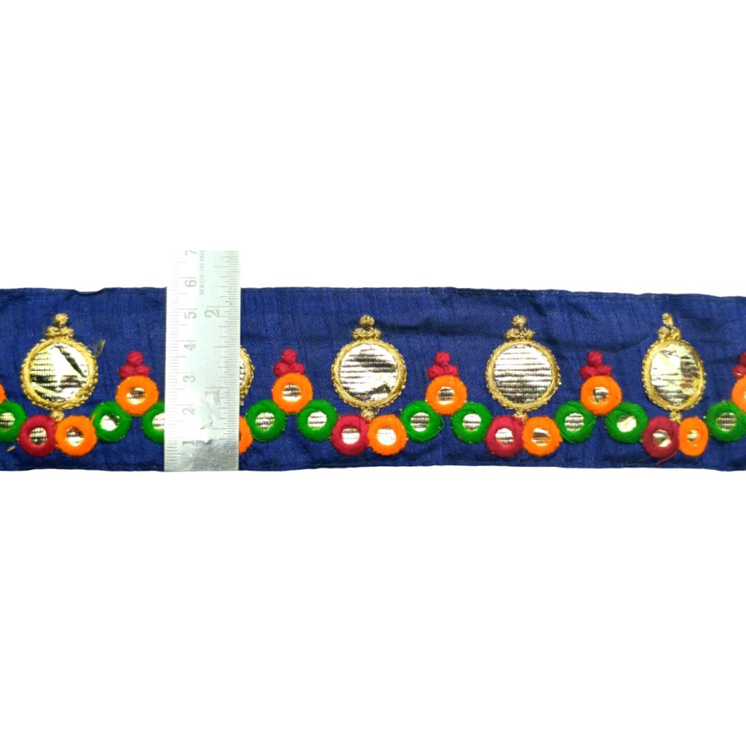 Decorative ribbon with colorful circular patterns on a blue background, accompanied by a ruler for scale.