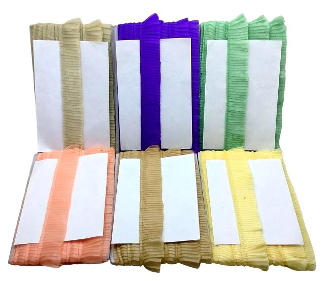 Set of colorful folded cloths with white labels on a white background