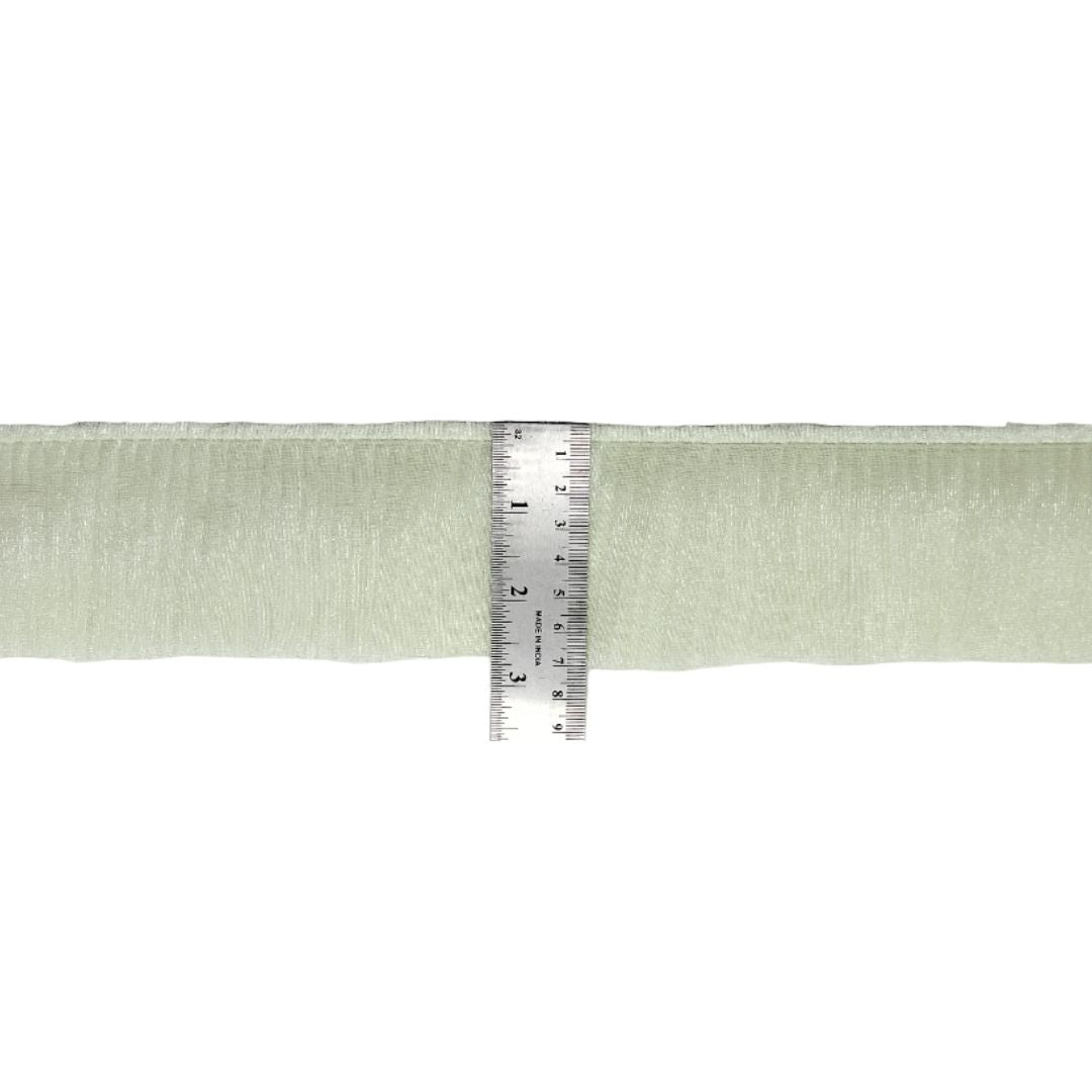 Light green ribbon with a ruler for measurement on a white background