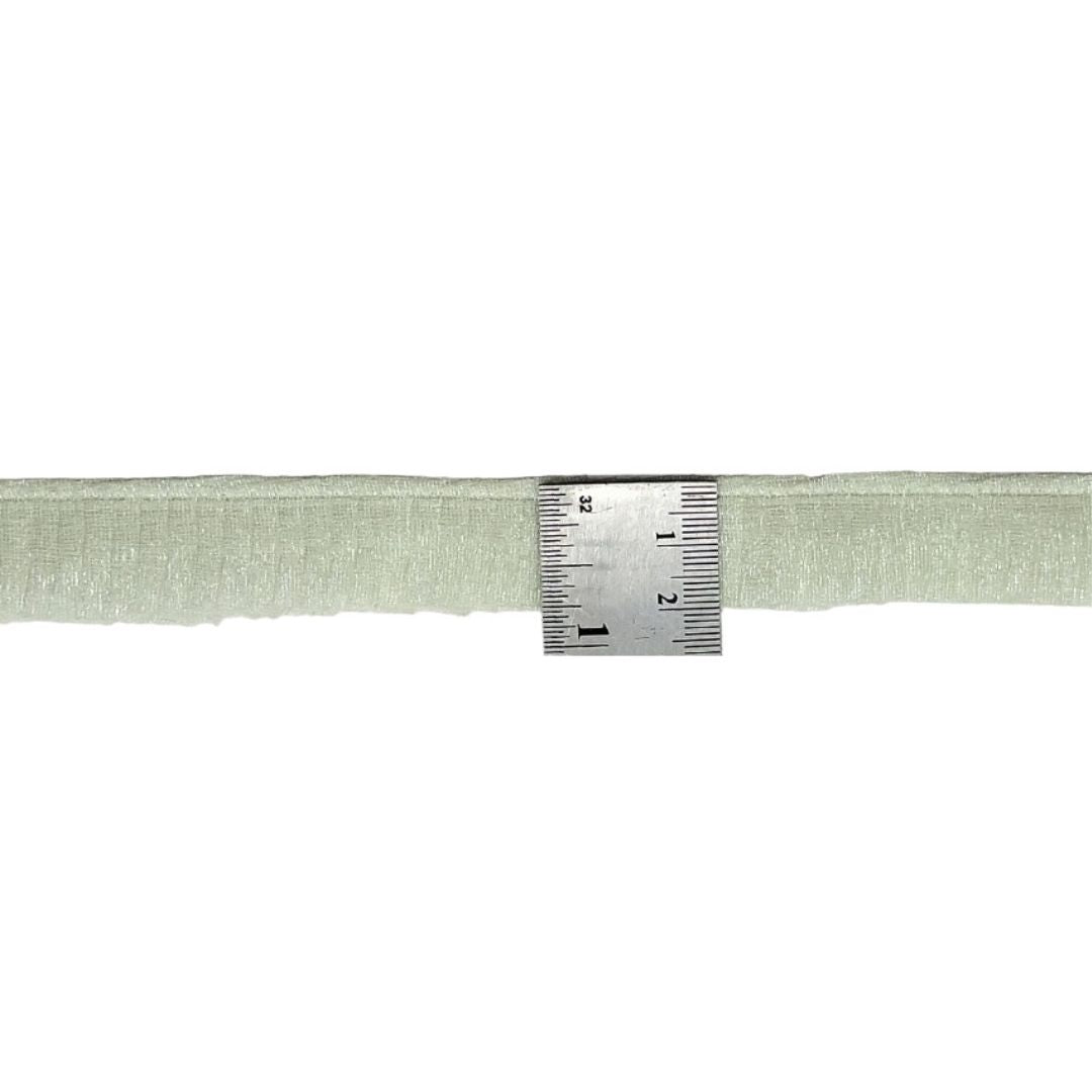 Green fabric strip with a ruler for measurement on a white background
